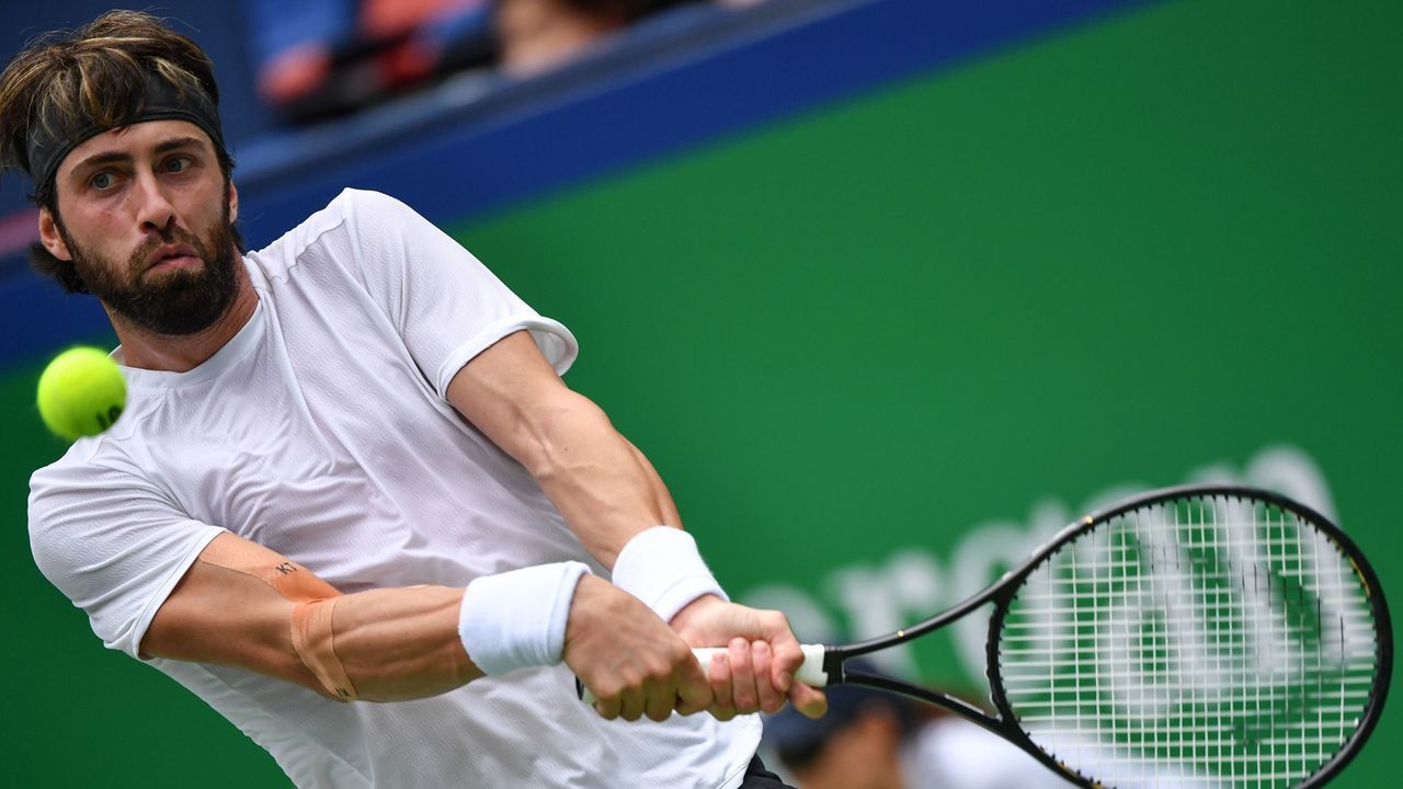 Nikoloz Basilashvili of Georgia hits a return against Radu Albot of Moldova during their first round men's singles match at the Shanghai Masters tennis tournament in Shanghai on October 6, 2019.