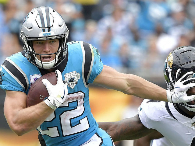 CHARLOTTE, NORTH CAROLINA - OCTOBER 06: Christian McCaffrey #22 of the Carolina Panthers stiff-arms Josh Allen #41 of the Jacksonville Jaguars during the second half of their game at Bank of America Stadium on October 06, 2019 in Charlotte, North Carolina. The Panthers won 34-27.
