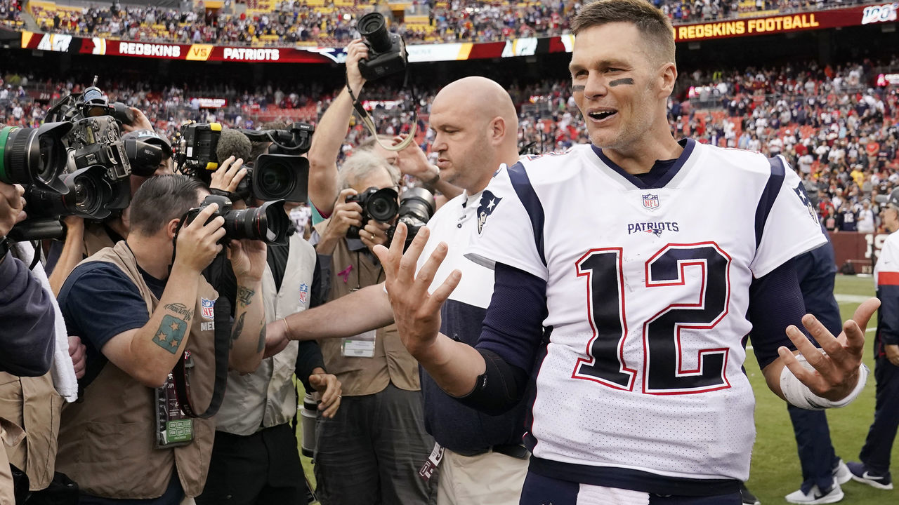 LANDOVER, MD - OCTOBER 06: Tom Brady #12 of the New England Patriots talks with Dwayne Haskins #7 of the Washington Redskins (not pictured) after the Patriots defeated the Redskins 33 to 7 at FedExField on October 6, 2019 in Landover, Maryland.