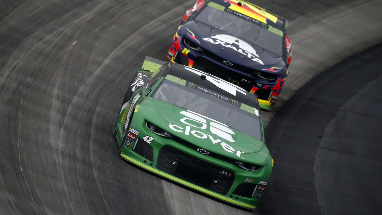 DOVER, DELAWARE - OCTOBER 06: Kyle Larson, driver of the #42 Clover Chevrolet, leads William Byron, driver of the #24 Axalta Chevrolet, during the Monster Energy NASCAR Cup Series Drydene 400 at Dover International Speedway on October 06, 2019 in Dover, Delaware.