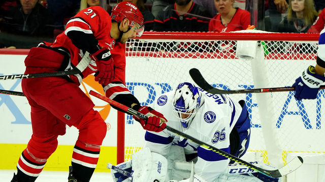 RALEIGH, NC - OCTOBER 6: Curtis McElhinney #35 of the Tampa Bay Lightning goes down in the crease to make the stop as Nino Niederreiter #21 attempts to deflect the puck into the net during an NHL game on October 6, 2019 at PNC Arena in Raleigh North Carolina.