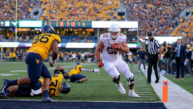 MORGANTOWN, WV - OCTOBER 05: Texas Longhorns offensive lineman Samuel Cosmi (52) runs 13-yards for a touchdown during the fourth quarter of the college football game between the Texas Longhorns and the West Virginia Mountaineers on October 5, 2019, at Mountaineer Field at Milan Puskar Stadium in Morgantown, WV.