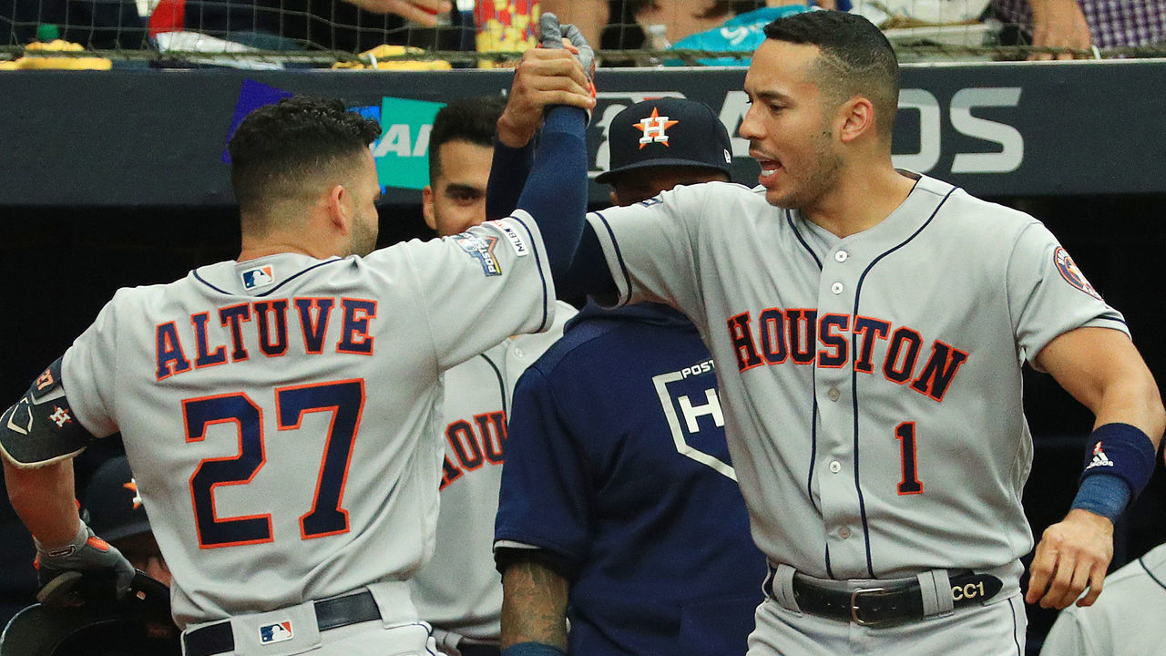 ST PETERSBURG, FLORIDA - OCTOBER 07: Jose Altuve #27 of the Houston Astros celebrates with Carlos Correa #1 after hitting a solo home run off Charlie Morton #50 of the Tampa Bay Rays (not pictured) during the first inning in Game Three of the American League Division Series at Tropicana Field on October 07, 2019 in St Petersburg, Florida.