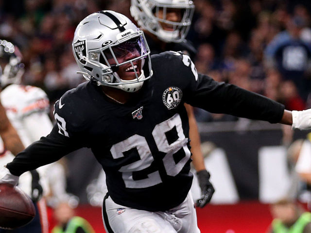 Oakland Raiders Josh Jacobs celebrates scoring his side's 1st touchdown with teammates during the NFL International Series match at Tottenham Hotspur Stadium, London.