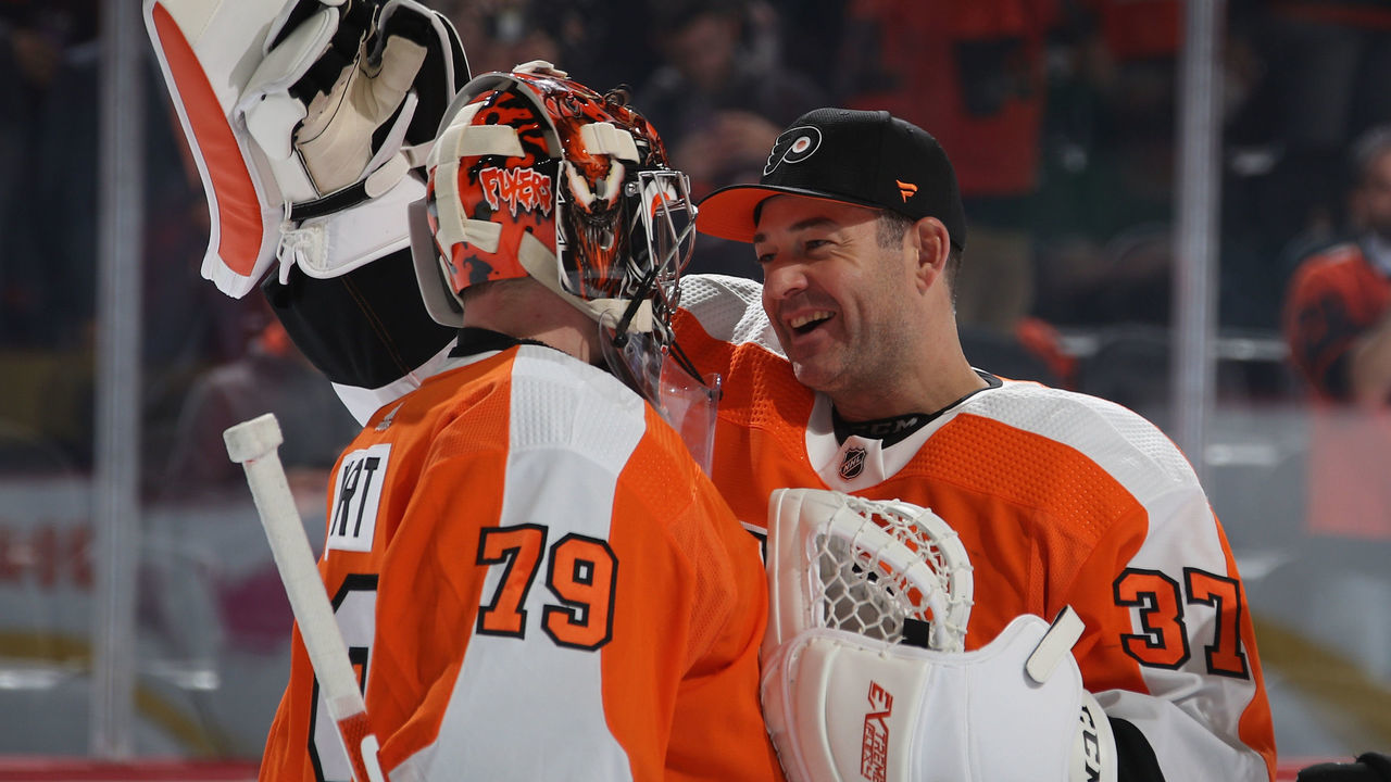 PHILADELPHIA, PENNSYLVANIA - OCTOBER 09: Carter Hart #79 of the Philadelphia Flyers celebrates his 4-0 shut-out against the New Jersey Devils along with Brian Elliott #37 at the Wells Fargo Center on October 09, 2019 in Philadelphia, Pennsylvania.