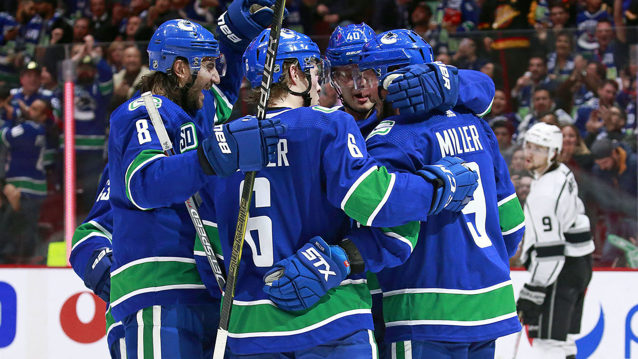 VANCOUVER, BC - OCTOBER 9: J.T. Miller #9 of the Vancouver Canucks is congratulated by teammates Brock Boeser #6 and Christopher Tanev #8 after scoring during their NHL game against the Los Angeles Kings at Rogers Arena October 9, 2019 in Vancouver, British Columbia, Canada.