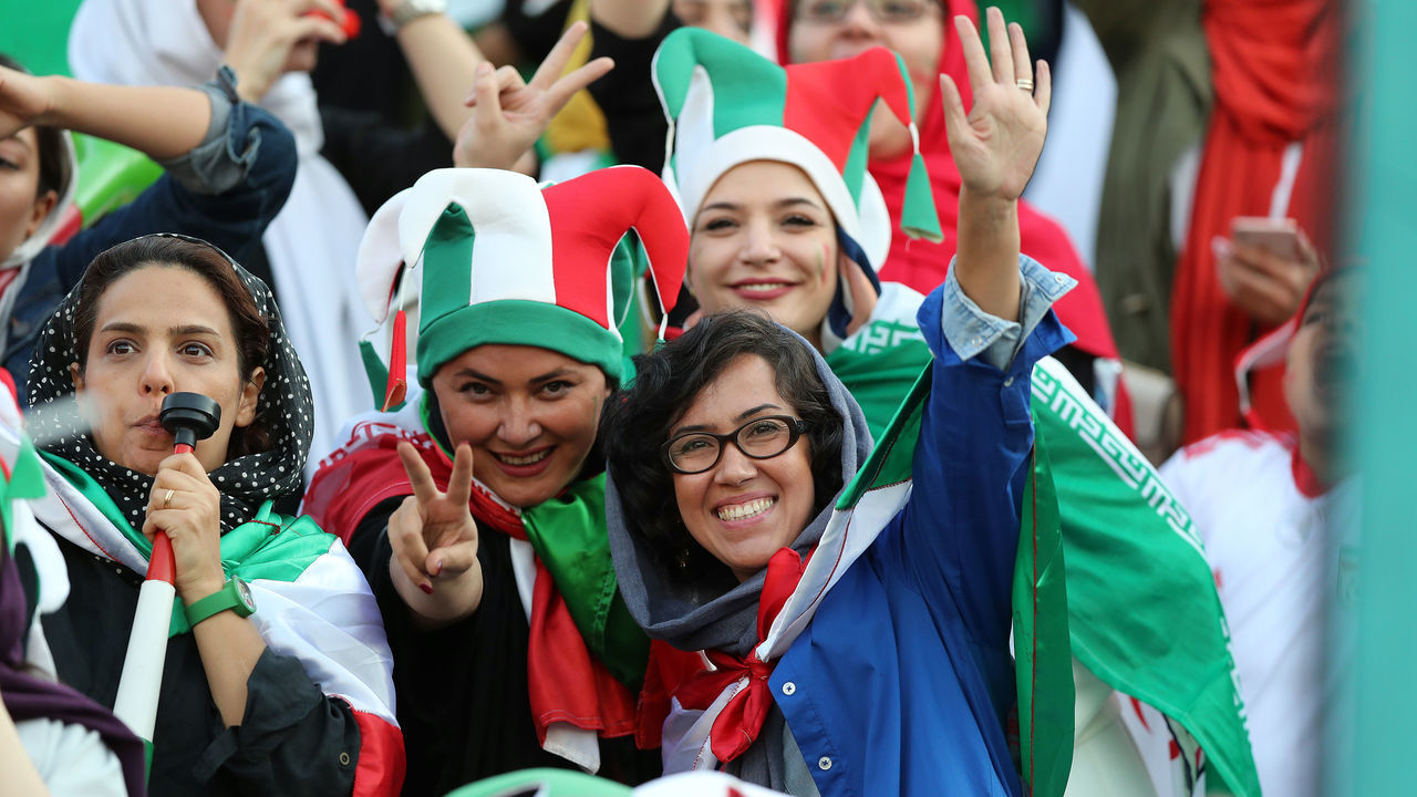 TEHRAN, IRAN - OCTOBER 10: Iranian Women's fans cheer during the FIFA World Cup Qualifier match between Iran and Cambodia at Azadi Stadium on October 10, 2019 in Tehran, Iran.