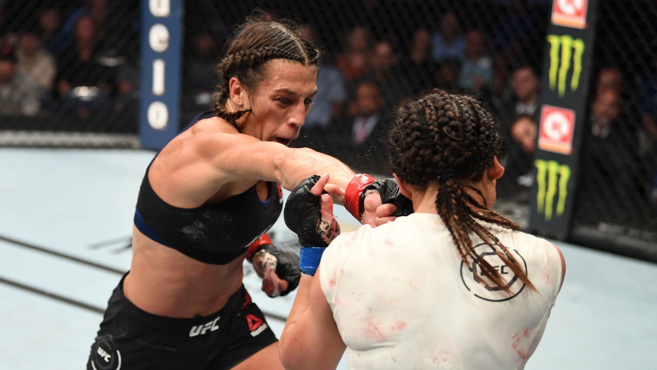 TAMPA, FLORIDA - OCTOBER 12: (L-R) Joanna Jedrzejczyk of Poland punches Michelle Waterson in their women's strawweight bout during the UFC Fight Night event at Amalie Arena on October 12, 2019 in Tampa, Florida.