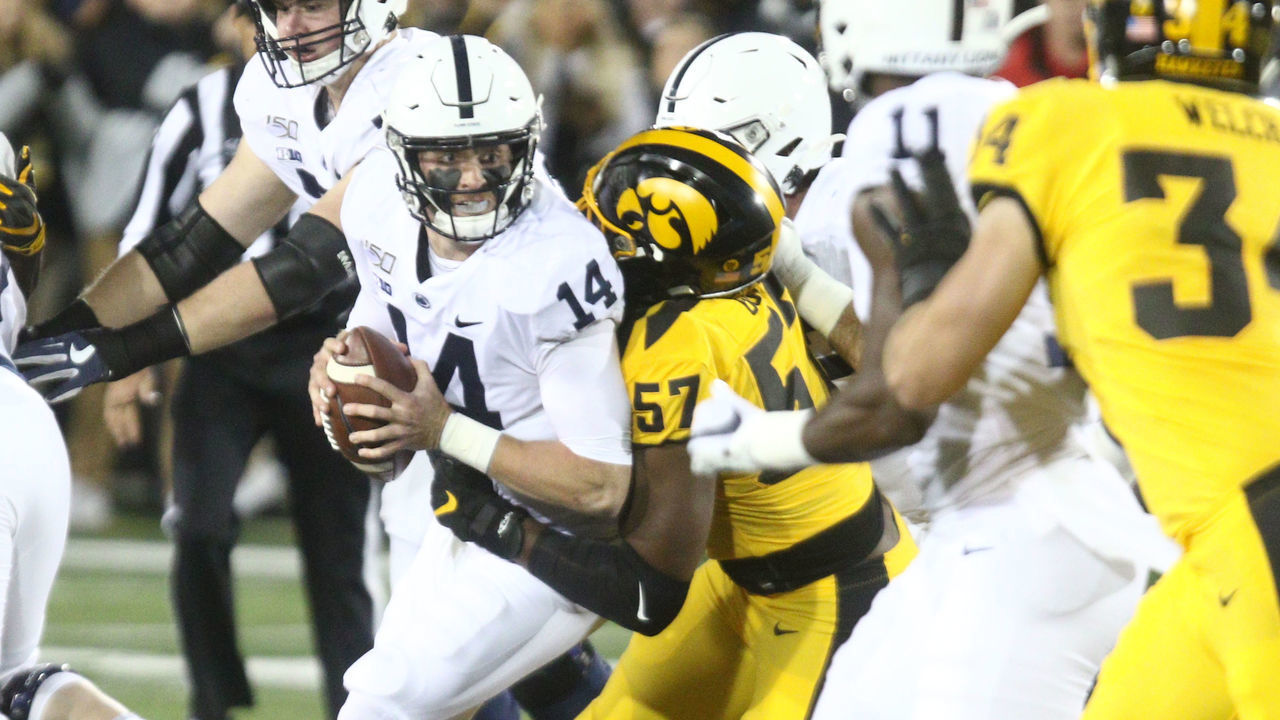 IOWA CITY, IOWA- OCTOBER 12: Quarterback Sean Clifford #14 of the Penn State Nittany Lions is sacked in the first half by defensive lineman Chauncey Golston #57 of the Iowa Hawkeyes, on October 12, 2019 at Kinnick Stadium in Iowa City, Iowa.
