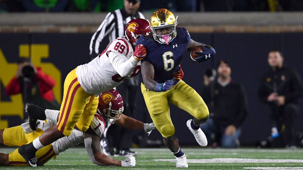 SOUTH BEND, IN - OCTOBER 12: DNotre Dame Fighting Irish running back Tony Jones Jr. (6) battles with USC Trojans defensive lineman Christian Rector (89) in game action during a game between Notre Dame Fighting Irish and the USC Trojans on October 12, 2019 at Notre Dame Stadium in South Bend, IN.