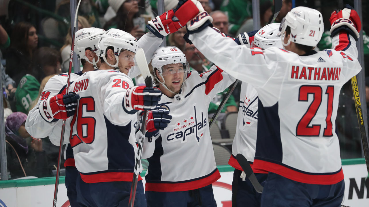 DALLAS, TX - OCTOBER 12: John Carlson #74, Brendan Leipsic #28, Nic Dowd #26 and Garnet Hathaway #21 of the Washington Capitals celebrate a goal against the Dallas Stars at the American Airlines Center on October 12, 2019 in Dallas, Texas.
