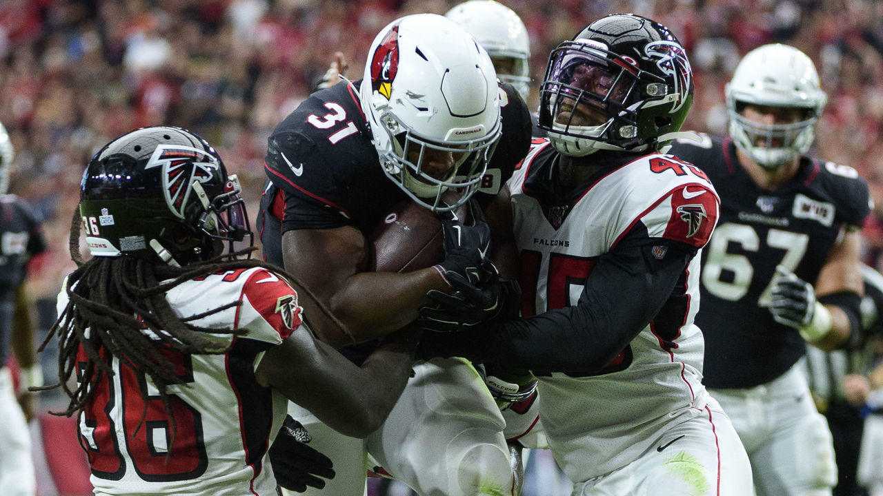 GLENDALE, ARIZONA - OCTOBER 13: Running back David Johnson #31 of the Arizona Cardinals carries the ball against defensive back Kemal Ishmael #36 and linebacker Deion Jones #45 of the Atlanta Falcons in the first half of the NFL game at State Farm Stadium on October 13, 2019 in Glendale, Arizona.