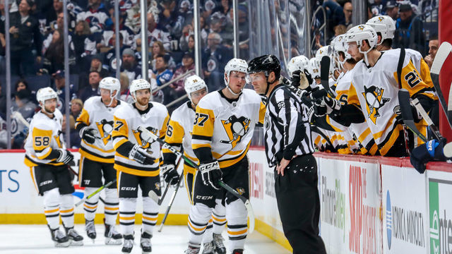 WINNIPEG, MB - OCTOBER 13: Sam Lafferty #37 of the Pittsburgh Penguins leads teammates to the bench to celebrate a second period goal against the Winnipeg Jets at the Bell MTS Place on October 13, 2019 in Winnipeg, Manitoba, Canada.
