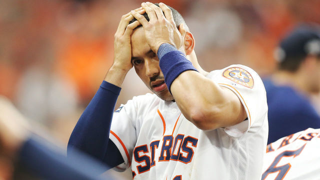 HOUSTON, TEXAS - OCTOBER 13: Carlos Correa #1 of the Houston Astros reacts after a security guard was hit by a foul ball in game two of the American League Championship Series between the Houston Astros and the New York Yankees at Minute Maid Park on October 13, 2019 in Houston, Texas.