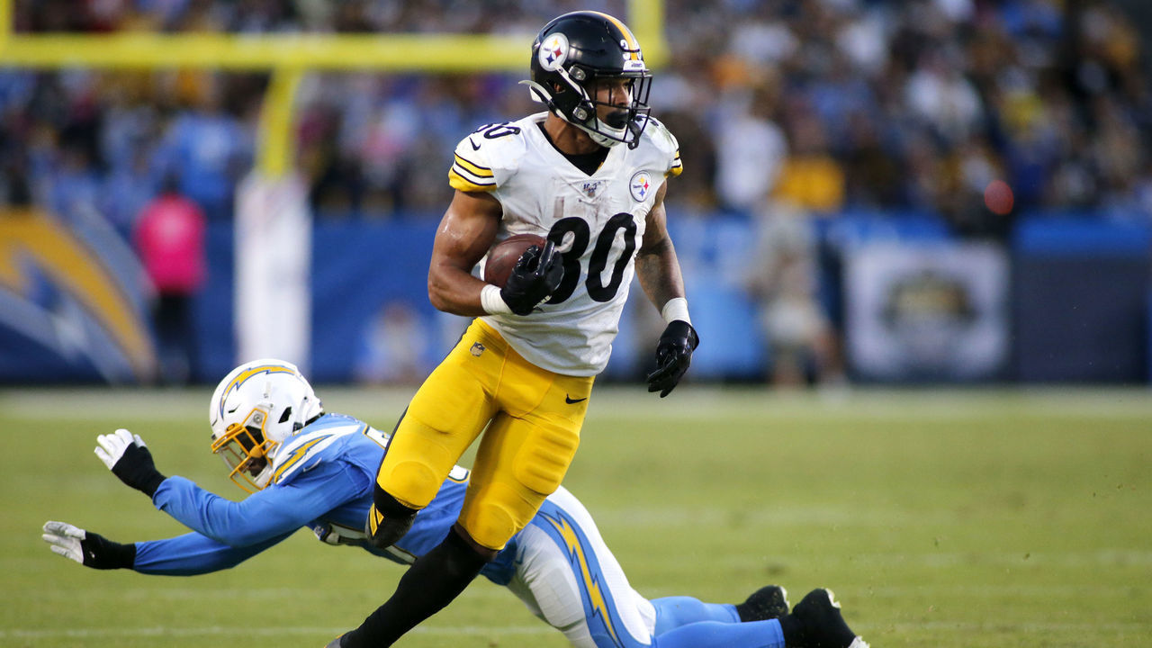 CARSON, CALIFORNIA - OCTOBER 13: Running back James Conner #30 of the Pittsburgh Steelers breaks through a tackle by outside linebacker Jatavis Brown #57 of the Los Angeles Chargers for a touchdown in the second quarter at Dignity Health Sports Park on October 13, 2019 in Carson, California.