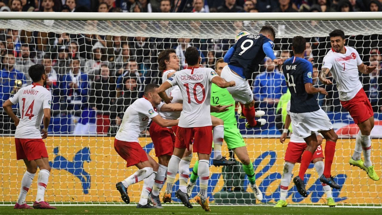 France's forward Olivier Giroud (3rdR) heads the ball to score the opener during the Euro 2020 Group H qualification football match between France and Turkey at the Stade de France in Saint-Denis, outside Paris on October 14, 2019.