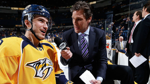 NASHVILLE, TN - JANUARY 18: Roman Josi #59 of the Nashville Predators discusses the game against the Colorado Avalanche with Stu Grimson during warm-ups at Bridgestone Arena on January 18, 2014 in Nashville, Tennessee.