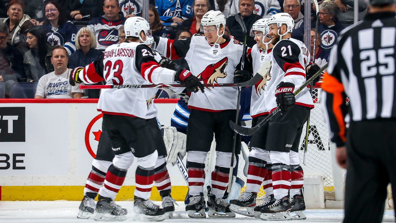 WINNIPEG, MB - OCTOBER 15: Oliver Ekman-Larsson #23, Phil Kessel #81, Christian Dvorak #18, Clayton Keller #9 and Derek Stepan #21 of the Arizona Coyotes celebrate a second period goal against the Winnipeg Jets at the Bell MTS Place on October 15, 2019 in Winnipeg, Manitoba, Canada.