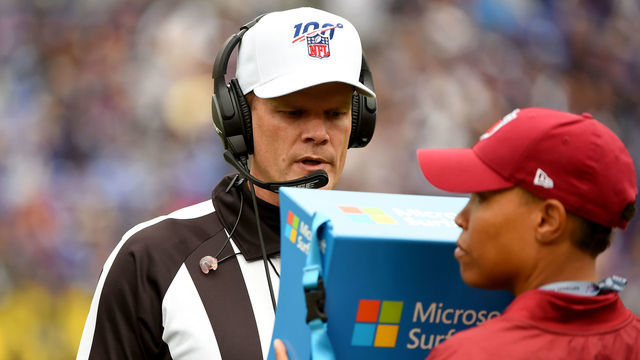 BALTIMORE, MD - OCTOBER 13: Referee Clay Martin #19 reviews a play on a Microsoft Surface tablet during the first half between the Baltimore Ravens and the Cincinnati Bengals at M&T Bank Stadium on October 13, 2019 in Baltimore, Maryland.