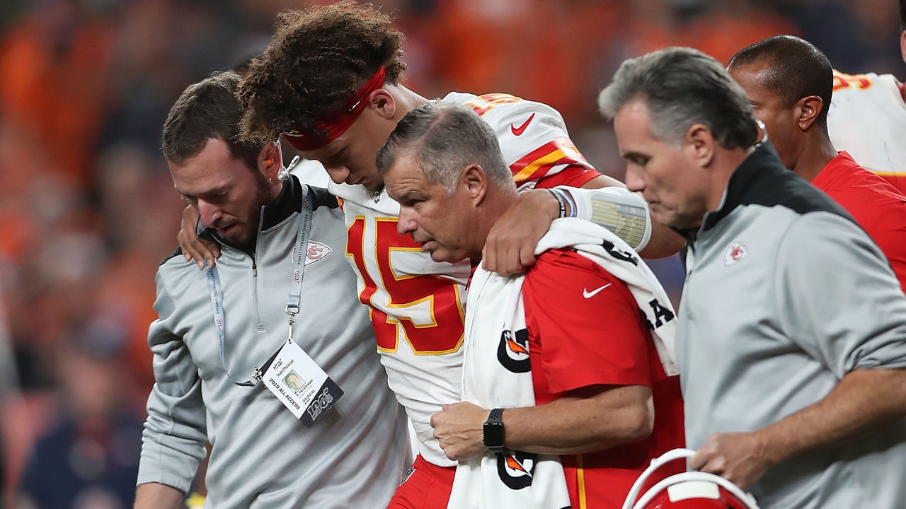 DENVER, COLORADO - OCTOBER 17: Quarterback Patrick Mahomes #15 of the Kansas City Chiefs is escorted off the field after an injury in the first half against the Denver Broncos in the game at Broncos Stadium at Mile High on October 17, 2019 in Denver, Colorado.