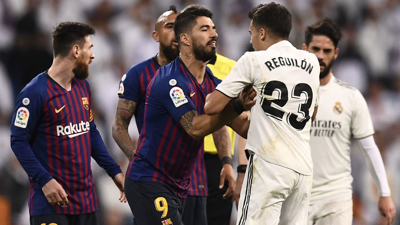 Barcelona's Uruguayan forward Luis Suarez (C) pushes Real Madrid's Spanish defender Sergio Reguilon during the Spanish league football match between Real Madrid CF and FC Barcelona at the Santiago Bernabeu stadium in Madrid on March 2, 2019.