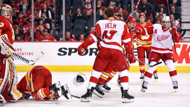 CALGARY, AB - OCTOBER 17: Calgary Flames Defenceman Travis Hamonic (24) goes after Detroit Red Wings Left Wing Darren Helm (43) in response to a slash on Calgary Flames Right Wing Elias Lindholm (28) during the third period of an NHL game where the Calgary Flames hosted the Detroit Red Wings on October 17, 2019, at the Scotiabank Saddledome in Calgary, AB.