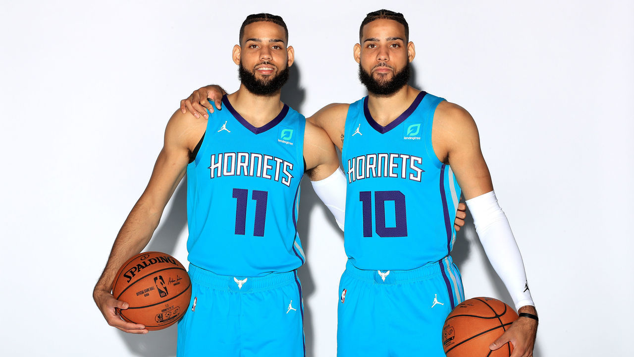CHARLOTTE, NORTH CAROLINA - SEPTEMBER 30: (L-R) Cody Martin #11 and Caleb Martin #10 of the Charlotte Hornets pose for a portrait during Charlotte Hornets Media Day at Spectrum Center on September 30, 2019 in Charlotte, North Carolina.