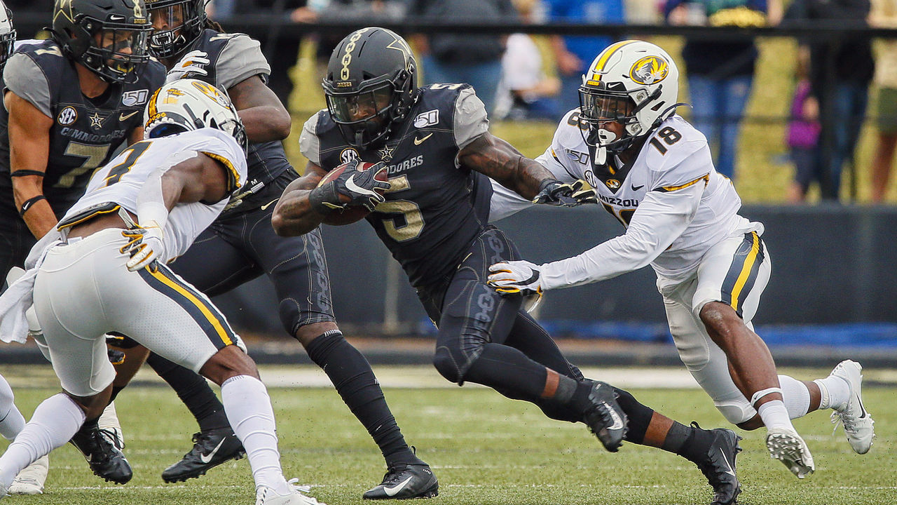 NASHVILLE, TENNESSEE - OCTOBER 19: Ke'Shawn Vaughn #5 of the Vanderbilt Commodores is pursued by Joshuah Bledsoe #18 of the Missouri Tigers during the first half at Vanderbilt Stadium on October 19, 2019 in Nashville, Tennessee.