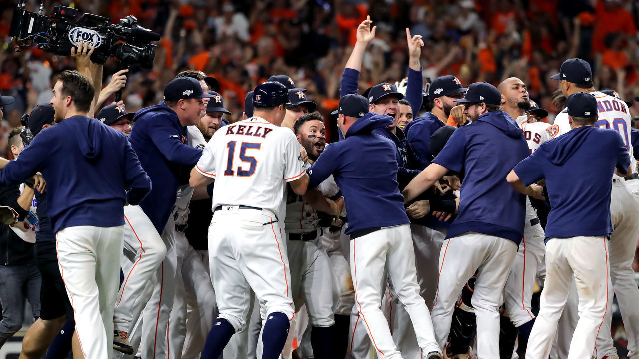 HOUSTON, TEXAS - OCTOBER 19: Jose Altuve #27 of the Houston Astros is congratulated by his teammates following his ninth inning walk-off two-run home run to defeat the New York Yankees 6-4 in game six of the American League Championship Series at Minute Maid Park on October 19, 2019 in Houston, Texas. The Astros defeated the Yankees 6-4.