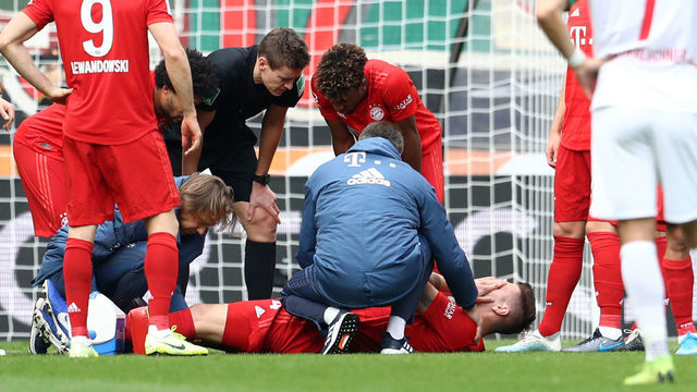 AUGSBURG, GERMANY - OCTOBER 19: Niklas Sule of FC Bayern Munich receives medical treatment during the Bundesliga match between FC Augsburg and FC Bayern Muenchen at WWK-Arena on October 19, 2019 in Augsburg, Germany.