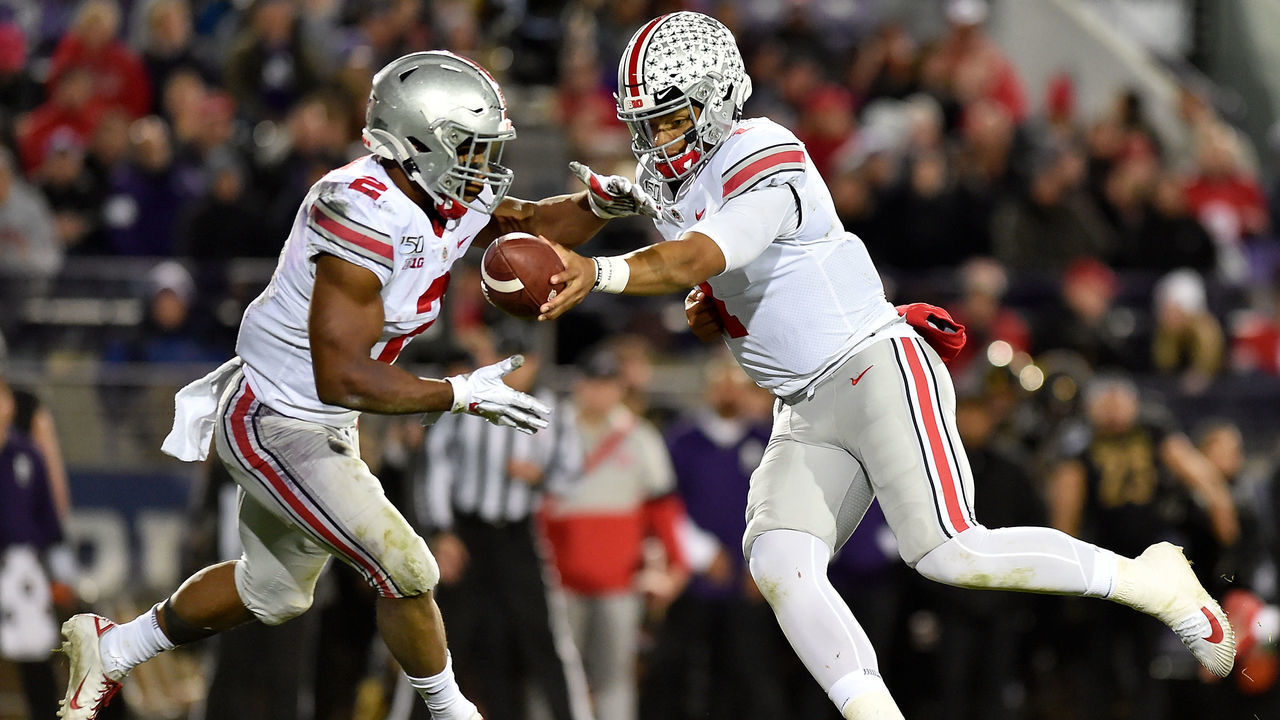 EVANSTON, ILLINOIS - OCTOBER 18: Justin Fields #1 of the Ohio State Buckeyes hands the football to J.K. Dobbins #2 of the Ohio State Buckeyes in the third quarter against the Northwestern Wildcats at Ryan Field on October 18, 2019 in Evanston, Illinois.