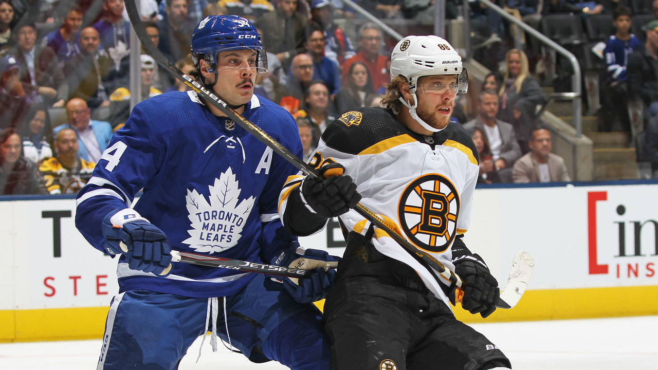 TORONTO, ON - OCTOBER 19: David Pastrnak #88 of the Boston Bruins skates against Auston Matthews #34 of the Toronto Maple Leafs during an NHL game at Scotiabank Arena on October 19, 2019 in Toronto, Ontario, Canada.