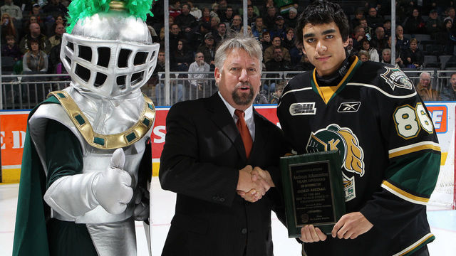 LONDON, CANADA - JANUARY 07: London Knights Governor Trevor Whiffen presents the Knights Andreas Athanasiou #86 with a plaque commemorating his gold medal at the 2011 World Under 17 Challenge prior to a game against the Brampton Battalion on January 7, 2011 at the John Labatt Centre in London, Canada. The Battalion defeated the Knights 8-0.