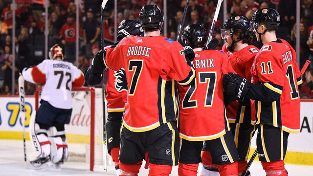 CALGARY, AB - OCTOBER 24: Calgary Flames Right Wing Austin Czarnik (27) celebrates a goal against Florida Panthers Goalie Sergei Bobrovsky (72) with Calgary Flames Defenceman T.J. Brodie (7), Left Wing Milan Lucic (17), Defenceman Rasmus Andersson (4) and Center Mikael Backlund (11) during the first period of an NHL game where the Calgary Flames hosted the Florida Panthers on October 24, 2019, at the Scotiabank Saddledome in Calgary, AB.