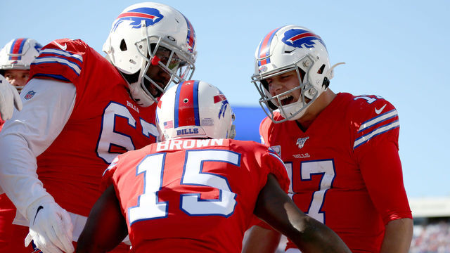 ORCHARD PARK, NY - OCTOBER 20: Quinton Spain #67, John Brown #15, and Josh Allen #17, all of the Buffalo Bills, celebrate after a touchdown during the fourth quarter of an NFL game against the Miami Dolphins at New Era Field on October 20, 2019 in Orchard Park, New York.