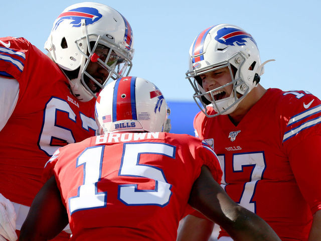 ORCHARD PARK, NY - OCTOBER 20: Quinton Spain #67, John Brown #15, and Josh Allen #17, all of the Buffalo Bills, celebrate after a touchdown during the fourth quarter of an NFL game against the Miami Dolphins at New Era Field on October 20, 2019 in Orchard Park, New York.