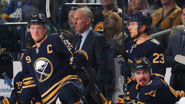BUFFALO, NY - OCTOBER 11: Jack Eichel #9, head coach Ralph Krueger, Sam Reinhart #23 and Marcus Johansson #90 of the Buffalo Sabres watch the action against the Florida Panthers during an NHL game on October 11, 2019 at KeyBank Center in Buffalo, New York.