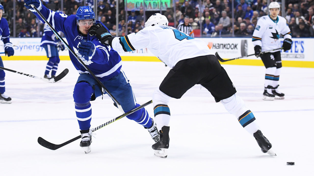 TORONTO, ON - NOVEMBER 28: Toronto Maple Leafs center Auston Matthews (34) battles for a puck with San Jose Sharks defenseman Brenden Dillon (4) during the second period in a game between the San Jose Sharks and the Toronto Maple Leafs at the Scotiabank Arena in Toronto, Ontario Canada.