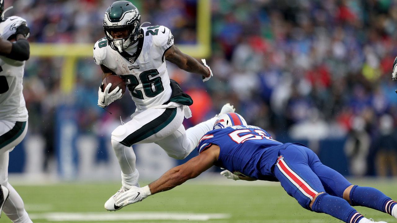 ORCHARD PARK, NEW YORK - OCTOBER 27: Miles Sanders #26 of the Philadelphia Eagles runs the ball as Matt Milano #58 of the Buffalo Bills attempts to tackle him during the third quarter of an NFL game at New Era Field on October 27, 2019 in Orchard Park, New York.