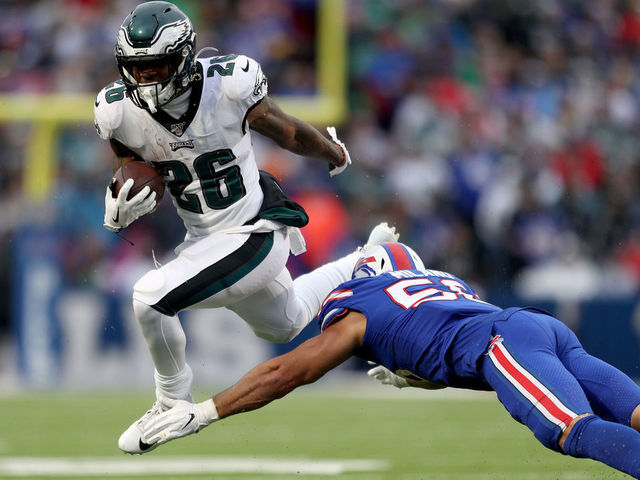 ORCHARD PARK, NEW YORK - OCTOBER 27: Miles Sanders #26 of the Philadelphia Eagles runs the ball as Matt Milano #58 of the Buffalo Bills attempts to tackle him during the third quarter of an NFL game at New Era Field on October 27, 2019 in Orchard Park, New York.