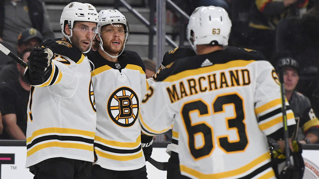 LAS VEGAS, NEVADA - OCTOBER 08: (L-R) Patrice Bergeron #37 and David Pastrnak #88 and Brad Marchand #63 of the Boston Bruins celebrate after Marchand and Bergeron assisted Pastrnak on a first-period goal against the Vegas Golden Knights during their game at T-Mobile Arena on October 8, 2019 in Las Vegas, Nevada.