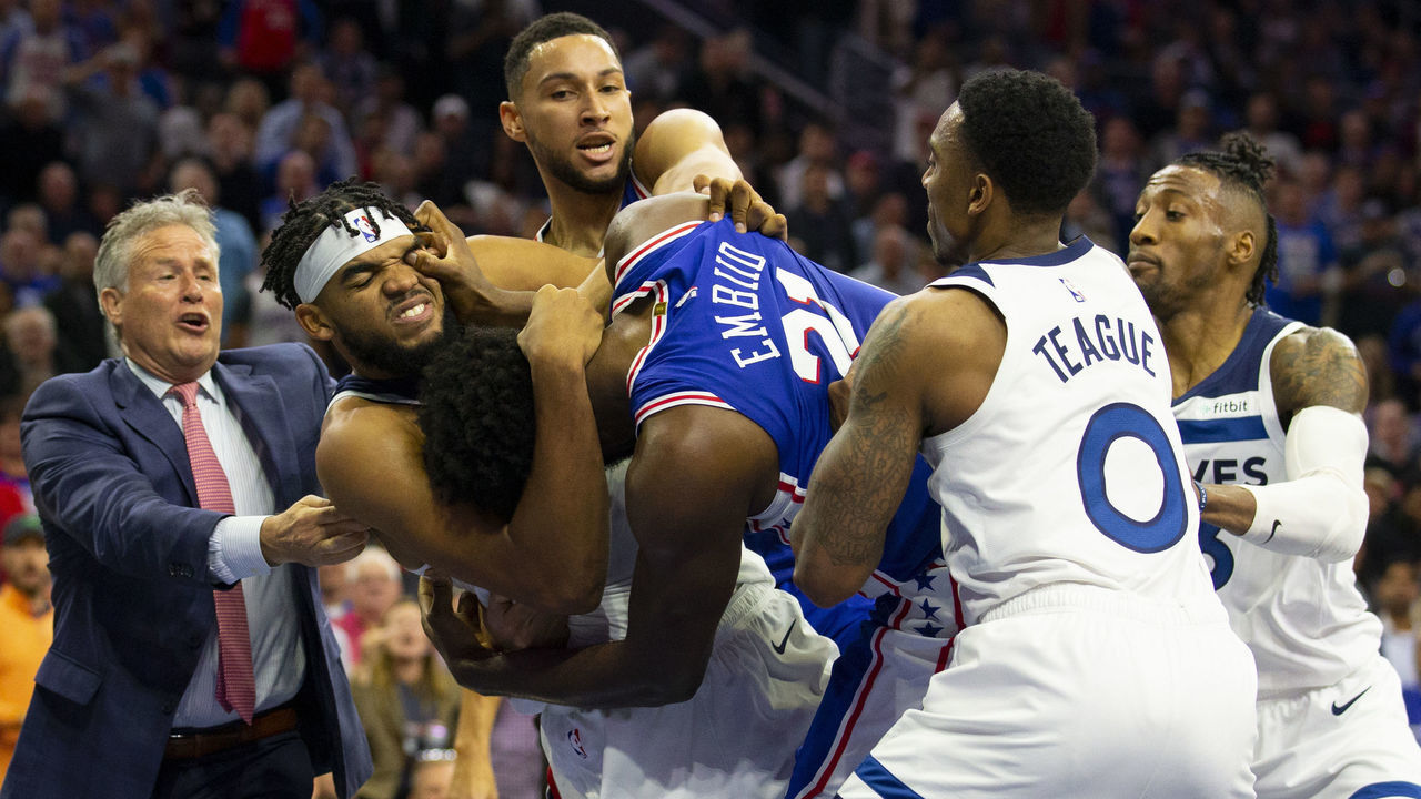 PHILADELPHIA, PA - OCTOBER 30: Joel Embiid #21 of the Philadelphia 76ers gets in a fight with Karl-Anthony Towns #32 of the Minnesota Timberwolves as head coach Brett Brown and Ben Simmons #25 of the Philadelphia 76ers try to break them apart along with Jeff Teague #0 and Robert Covington #33 of the Minnesota Timberwolves in the third quarter at the Wells Fargo Center on October 30, 2019 in Philadelphia, Pennsylvania.