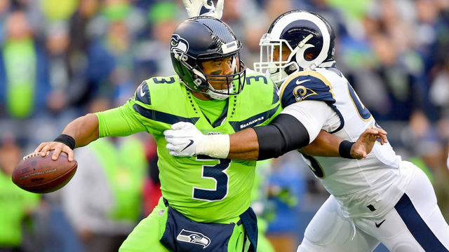 SEATTLE, WASHINGTON - OCTOBER 03: Russell Wilson #3 of the Seattle Seahawks is pressured by Aaron Donald #99 of the Los Angeles Rams during the first half of the game at CenturyLink Field on October 03, 2019 in Seattle, Washington.