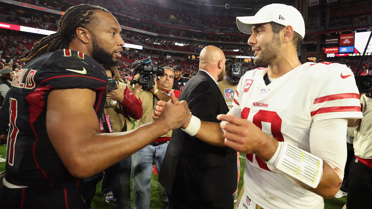 GLENDALE, ARIZONA - OCTOBER 31: Wide receiver Larry Fitzgerald #11 of the Arizona Cardinals and quarterback Jimmy Garoppolo #10 of the San Francisco 49ers shake hands following the NFL game at State Farm Stadium on October 31, 2019 in Glendale, Arizona. The 49ers defeated the Cardinals 28-25.