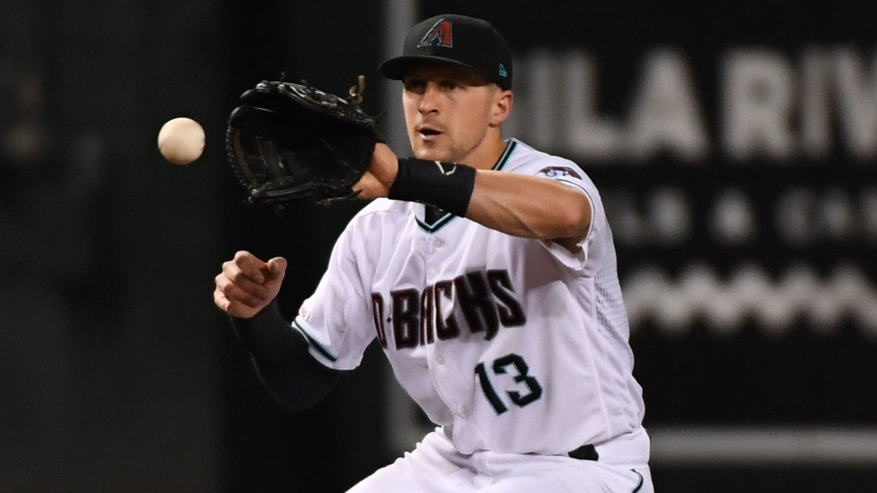 PHOENIX, ARIZONA - SEPTEMBER 24: Nick Ahemd #13 of the Arizona Diamondbacks makes a play on a bouncing ball against the St Louis Cardinals at Chase Field on September 24, 2019 in Phoenix, Arizona.