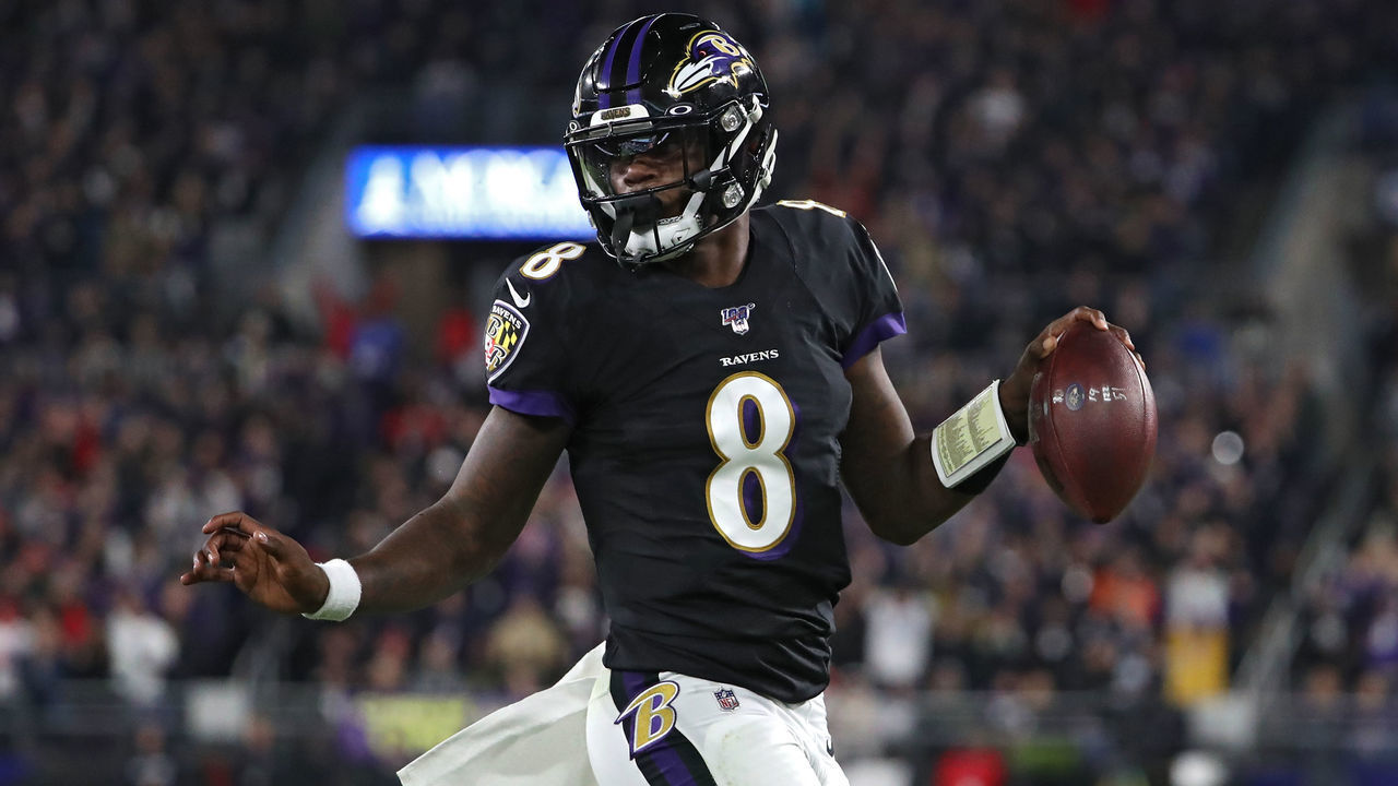 BALTIMORE, MARYLAND - NOVEMBER 03: Quarterback Lamar Jackson #8 of the Baltimore Ravens scores a first quarter touchdown against the New England Patriots at M&T Bank Stadium on November 3, 2019 in Baltimore, Maryland.