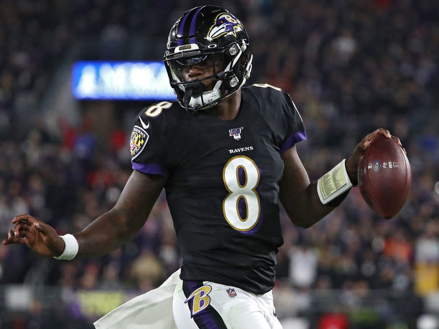 BALTIMORE, MARYLAND - NOVEMBER 03: Quarterback Lamar Jackson #8 of the Baltimore Ravens scores a first quarter touchdown against the New England Patriots at M&T Bank Stadium on November 3, 2019 in Baltimore, Maryland.