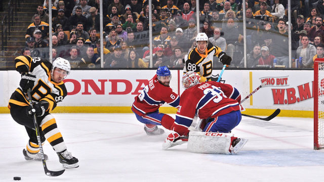 BOSTON, MA - JANUARY 14: Boston Bruins Right Wing David Pastrnak (88) tries to get the pass to Boston Bruins Left Wing Brad Marchand (63) who can't get control of it. During the Boston Bruins game against the Montreal Canadiens on January 14, 2019 at TD Garden in Boston, MA.