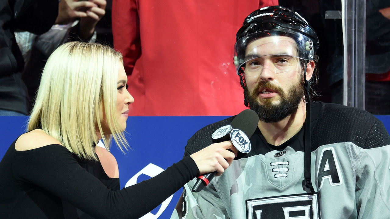 LOS ANGELES, CA - NOVEMBER 2: Reporter Carrlyn Bathe of Fox Sports West interviews Drew Doughty #8 of the Los Angeles Kings after his game winning goal during overtime against the Chicago Blackhawks at STAPLES Center on November 2, 2019 in Los Angeles, California.
