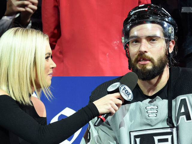 LOS ANGELES, CA - NOVEMBER 2: Reporter Carrlyn Bathe of Fox Sports West interviews Drew Doughty #8 of the Los Angeles Kings after his game winning goal during overtime against the Chicago Blackhawks at STAPLES Center on November 2, 2019 in Los Angeles, California.